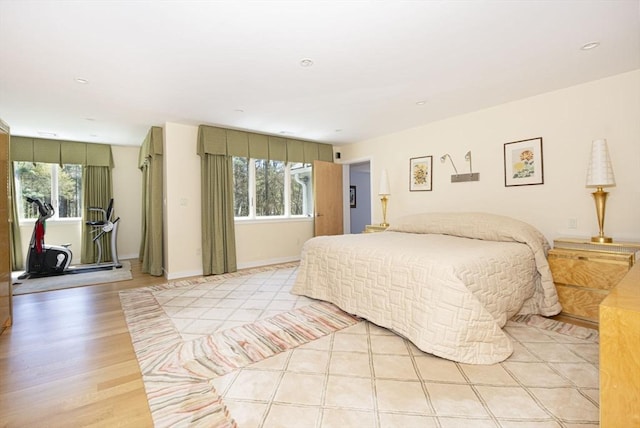 bedroom featuring multiple windows, light wood-type flooring, baseboards, and recessed lighting