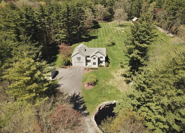 view of subject property featuring a forest
