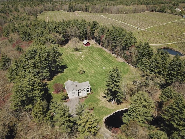 aerial view of property's location with rural landscape and a nearby body of water