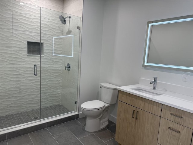bathroom with tile patterned floors, vanity, a stall shower, and toilet