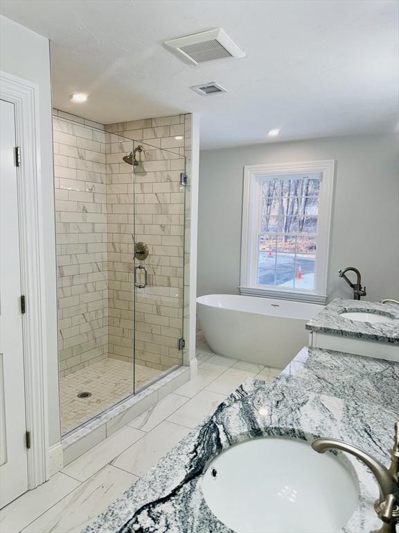 200A Randall Rd, Berlin, MA 01503 - bathroom with a shower stall, a freestanding bath, double vanity, and recessed lighting