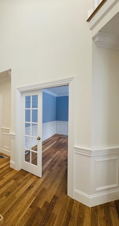 200A Randall Rd, Berlin, MA 01503 - hall featuring a decorative wall, wood finished floors, a wainscoted wall, and crown molding