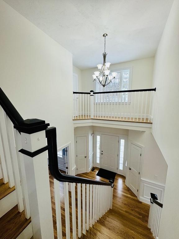 200A Randall Rd, Berlin, MA 01503 - entryway featuring stairway, a chandelier, wood finished floors, and a high ceiling