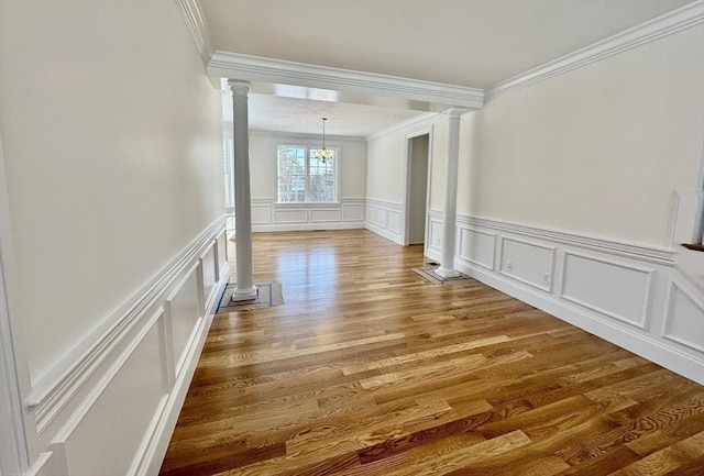 200A Randall Rd, Berlin, MA 01503 - unfurnished room with ornate columns, ornamental molding, a decorative wall, a chandelier, and wood finished floors