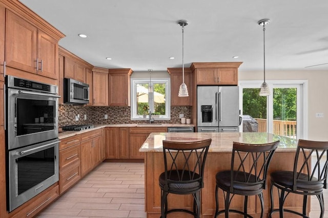 6 Myers Ln, Newbury, MA 01922 - kitchen featuring stainless steel appliances, a sink, backsplash, a breakfast bar, and recessed lighting