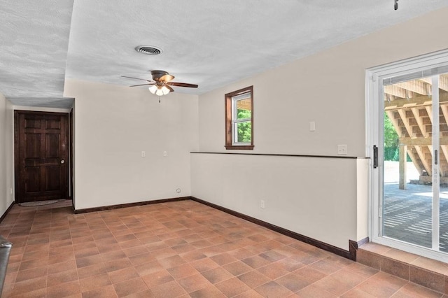 6 Myers Ln, Newbury, MA 01922 - spare room with baseboards, a ceiling fan, and a textured ceiling
