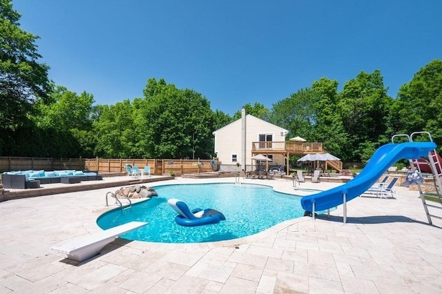 6 Myers Ln, Newbury, MA 01922 - view of swimming pool with a water slide, a patio, an outdoor living space, a diving board, and view of scattered trees