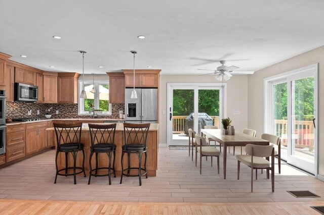 6 Myers Ln, Newbury, MA 01922 - kitchen featuring stainless steel appliances, backsplash, brown cabinets, and recessed lighting