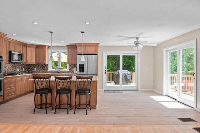 6 Myers Ln, Newbury, MA 01922 - kitchen featuring appliances with stainless steel finishes, decorative backsplash, brown cabinetry, and recessed lighting