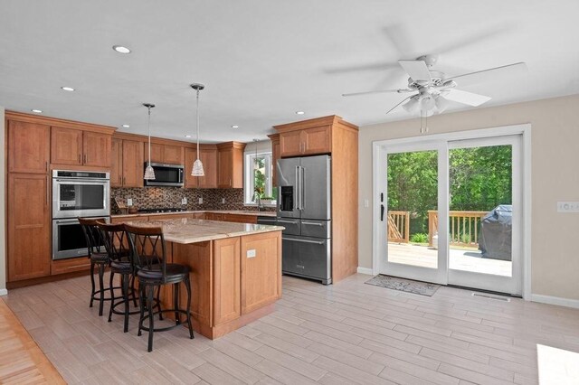 6 Myers Ln, Newbury, MA 01922 - kitchen with appliances with stainless steel finishes, backsplash, baseboards, a kitchen island, and ceiling fan
