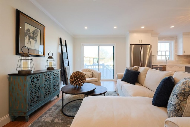 living room with crown molding and hardwood / wood-style flooring