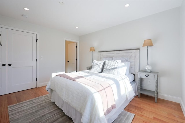 bedroom with wood-type flooring and a closet