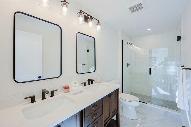 bathroom with vanity, toilet, and a shower with shower door