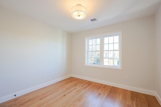 spare room featuring light wood-type flooring