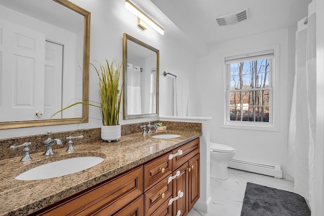 bathroom with vanity, toilet, and baseboard heating