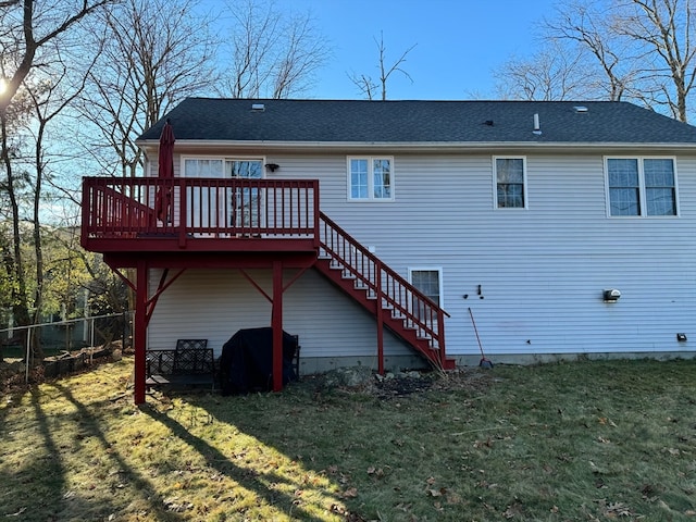 rear view of property with a lawn and a deck