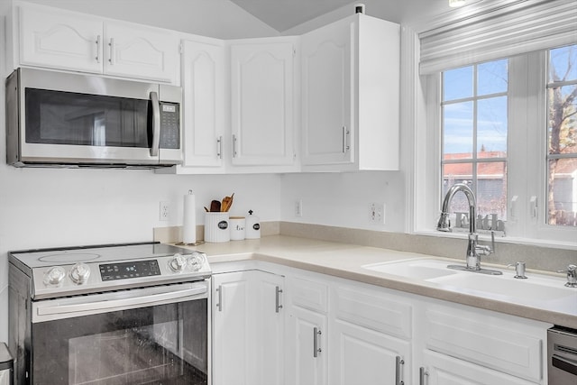 kitchen featuring white cabinetry, sink, and appliances with stainless steel finishes