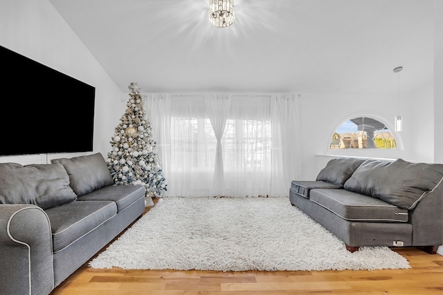 living room with hardwood / wood-style floors and lofted ceiling