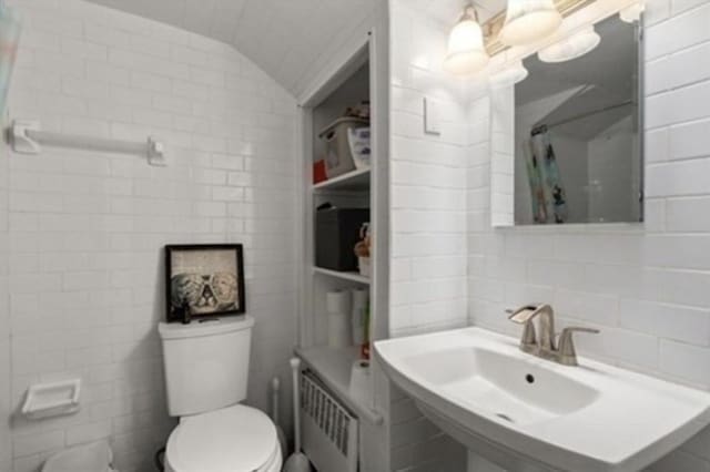 15 Trowbridge St Unit 12A, Cambridge, MA 02139 - bathroom featuring tile walls, toilet, a shower with shower curtain, radiator, and a sink