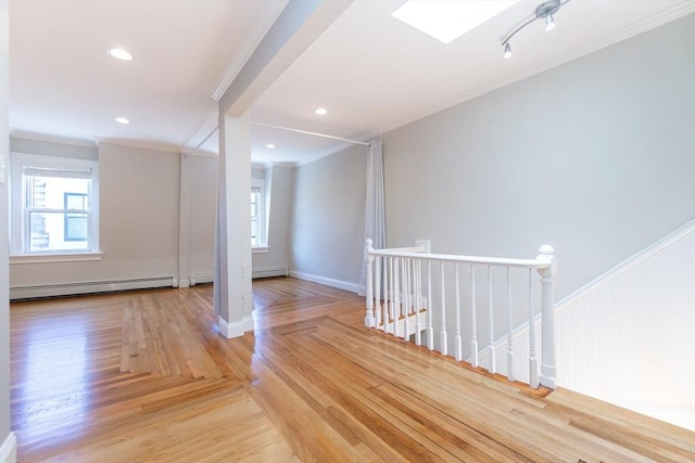 12 Springer St Unit 3, Boston, MA 02127 - unfurnished room featuring a baseboard heating unit, crown molding, healthy amount of natural light, wood finished floors, and recessed lighting
