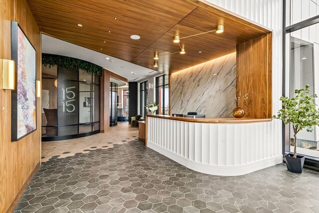reception area with wooden ceiling and recessed lighting