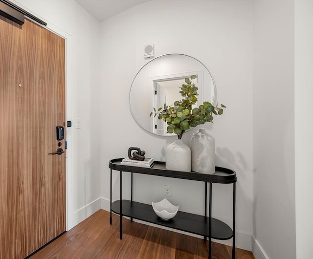 foyer entrance featuring wood finished floors and baseboards