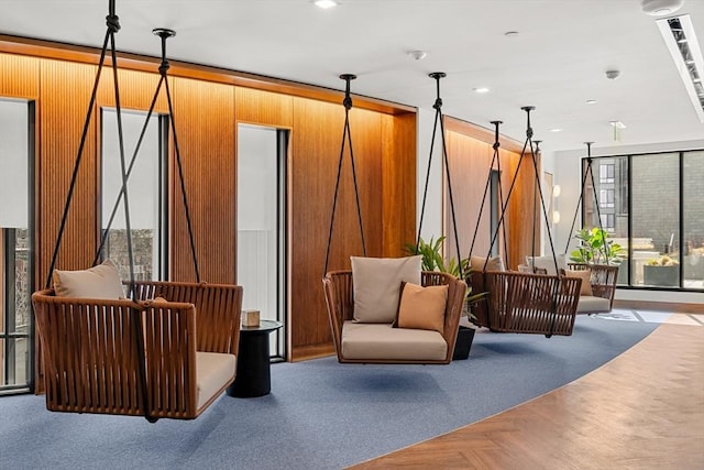 building lobby featuring wood walls and recessed lighting