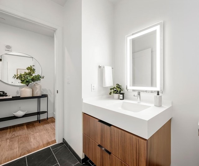 bathroom with vanity and baseboards