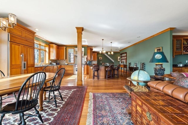 45 Joshua Rd, Wrentham, MA 02093 - living room featuring decorative columns, a chandelier, light wood finished floors, crown molding, and recessed lighting