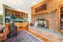 45 Joshua Rd, Wrentham, MA 02093 - living area with a brick fireplace and dark wood-style floors