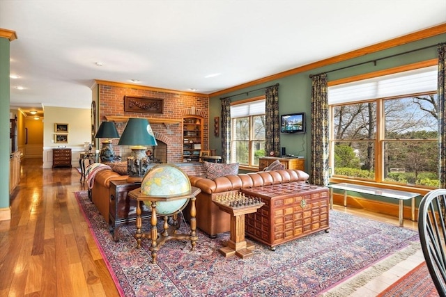 45 Joshua Rd, Wrentham, MA 02093 - living room featuring wood finished floors, ornamental molding, and a brick fireplace
