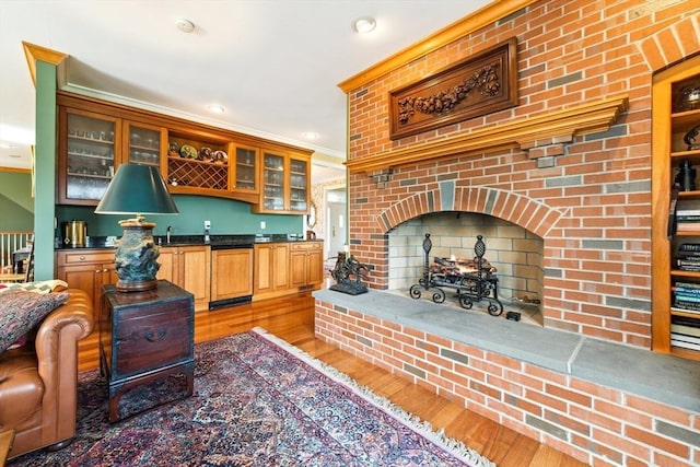 45 Joshua Rd, Wrentham, MA 02093 - kitchen with light wood-type flooring, dark countertops, glass insert cabinets, recessed lighting, and crown molding