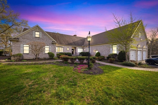 45 Joshua Rd, Wrentham, MA 02093 - view of front of home with a lawn, a chimney, an attached garage, and brick siding