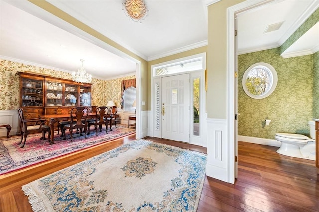 45 Joshua Rd, Wrentham, MA 02093 - foyer entrance featuring wallpapered walls, a chandelier, wood-type flooring, wainscoting, and ornamental molding