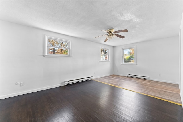 unfurnished room featuring a baseboard radiator, dark hardwood / wood-style floors, and a healthy amount of sunlight