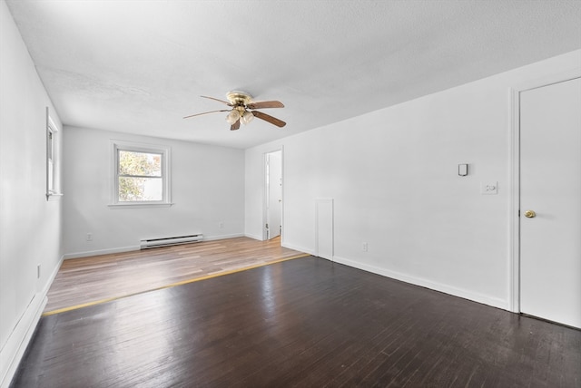 empty room featuring a textured ceiling, hardwood / wood-style flooring, a baseboard radiator, and ceiling fan