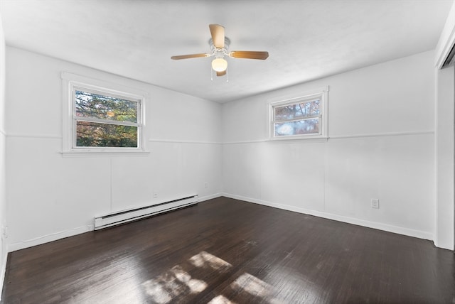 spare room featuring dark hardwood / wood-style flooring, ceiling fan, a baseboard radiator, and a wealth of natural light