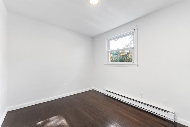 unfurnished room featuring a baseboard radiator and dark hardwood / wood-style floors