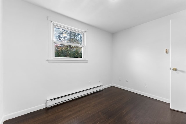 empty room featuring a baseboard radiator and dark wood-type flooring