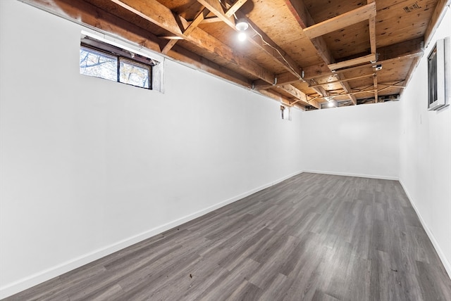 basement featuring dark wood-type flooring and wooden ceiling