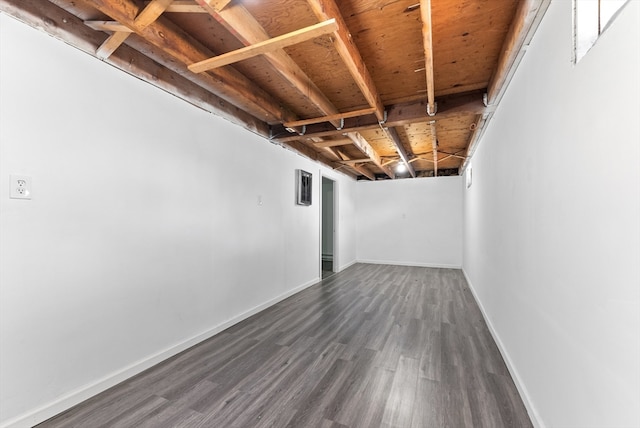 basement with dark hardwood / wood-style floors