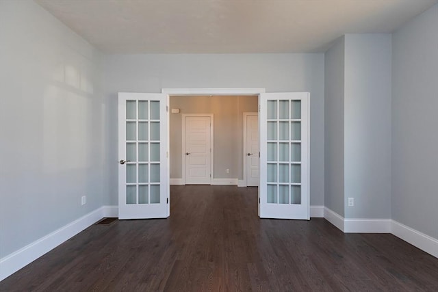 spare room with french doors, baseboards, and dark wood-style flooring