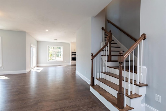 staircase featuring recessed lighting, wood finished floors, and baseboards