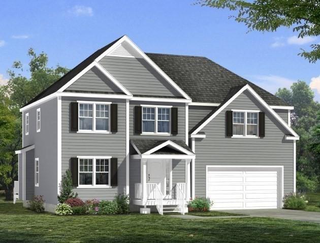 view of front facade featuring a front yard, a garage, and driveway