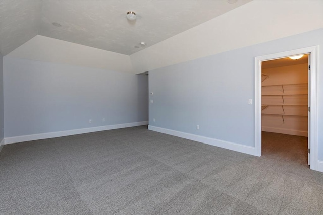 bonus room featuring lofted ceiling, baseboards, and carpet floors