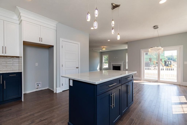 kitchen featuring dark wood-style floors, open floor plan, tasteful backsplash, and white cabinets