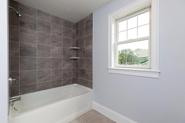 bathroom with baseboards, shower / bathtub combination, and tile patterned flooring