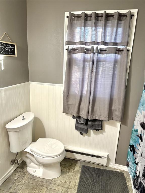 bathroom featuring toilet and baseboard heating