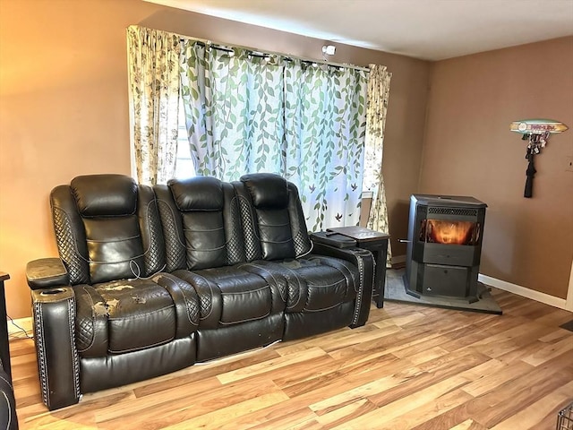 interior space featuring light wood-type flooring and a wood stove