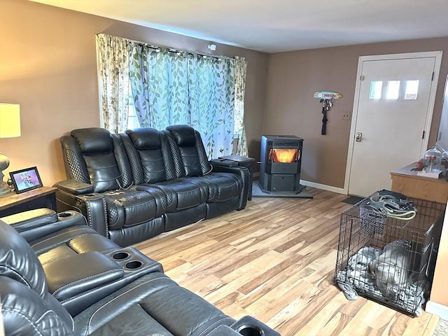 living room featuring hardwood / wood-style floors and a wood stove